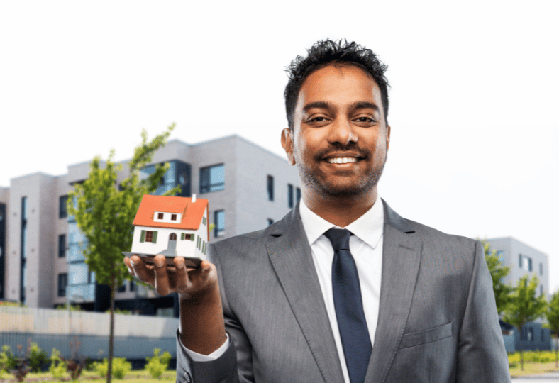 A real estate agent holding a model of a house ready to sell a home