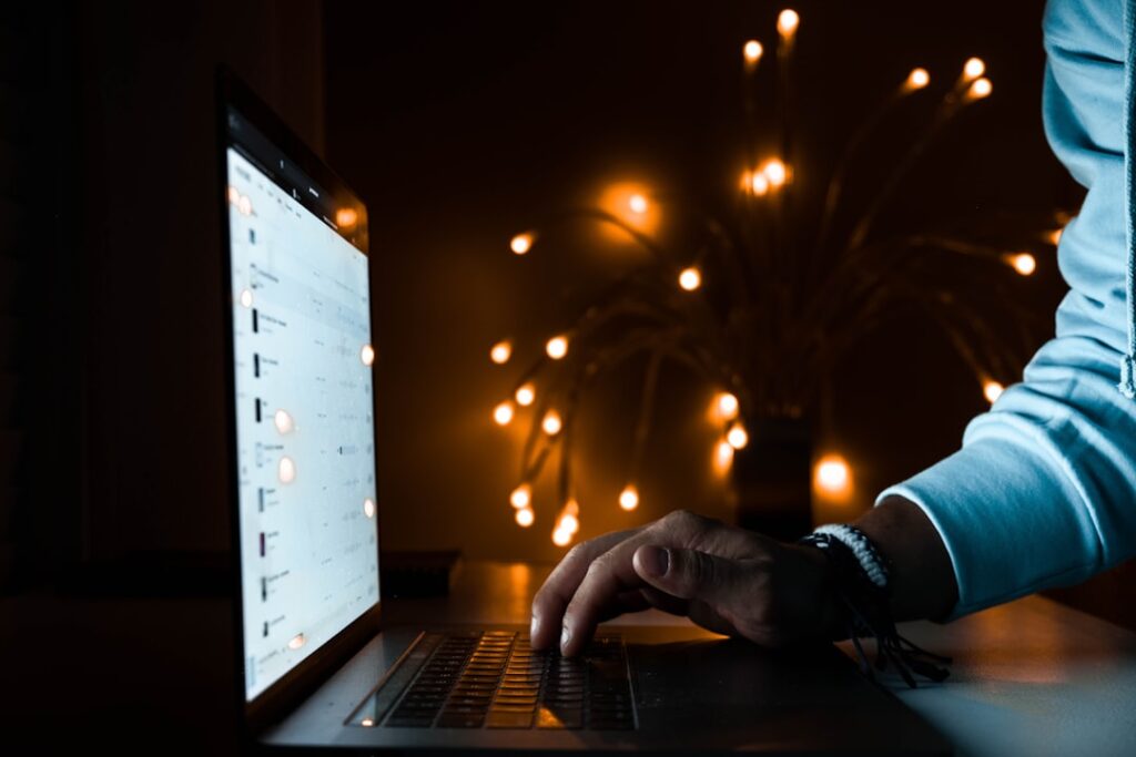 Person carefully examines a laptop screen with a magnifying glass, symbolizing a deep online investigation of a local comp...