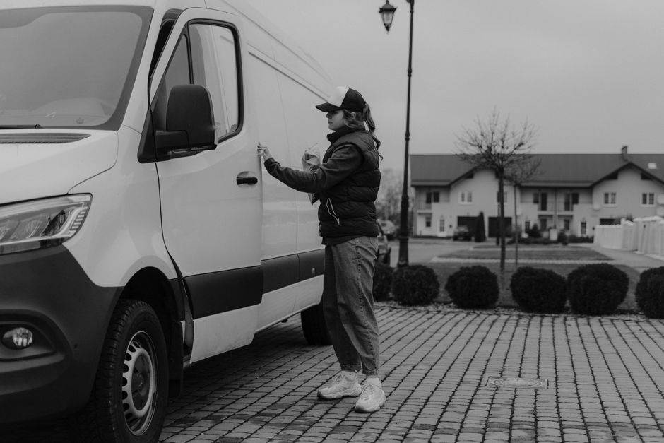 A clean, modern work van for a local home service business is parked on an empty suburban street, representing a company that is ready for customers but struggling with local visibility.